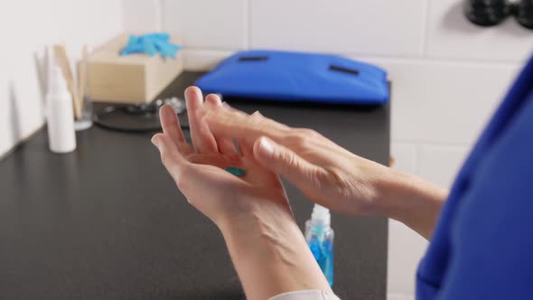 Doctor or Nurse Spraying Hand Sanitizer