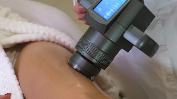 Close-up of vacuum massage with a special machine on women's legs. Slow motion.