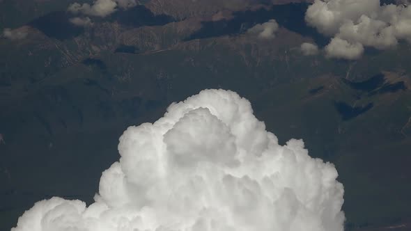 Aerial Clouds Exploding from Airplane Window