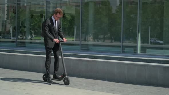 Businessman Getting To Work By Electric Scooter