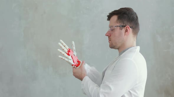 Portrait of Scientist Engineer Conducts Tests of Robotic Prosthetic Hand Trying To Move Fingers