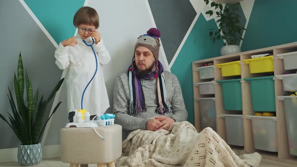 Father and Child Playing Clinic and Doctor Little Boy in Medical Gown with Stethoscope Treats and