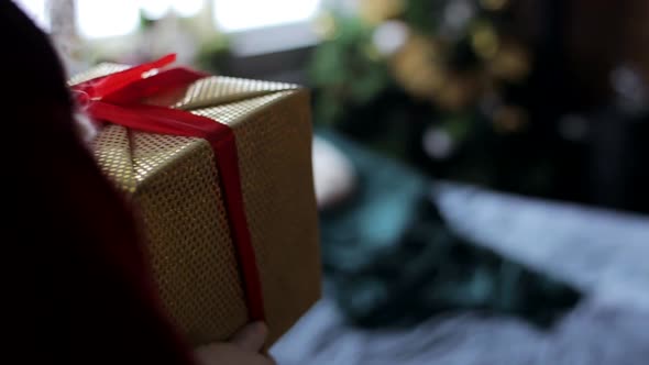 Overjoyed little girl holding a pile of presents, happy girl with gift box, happy girl with gift box