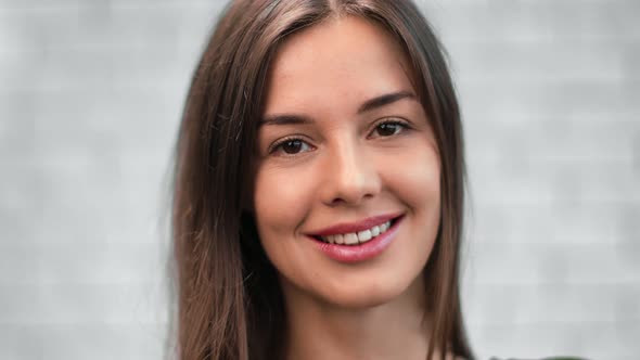 Closeup Portrait of Adorable Woman Smiling with Open Mouth Showing Teeth