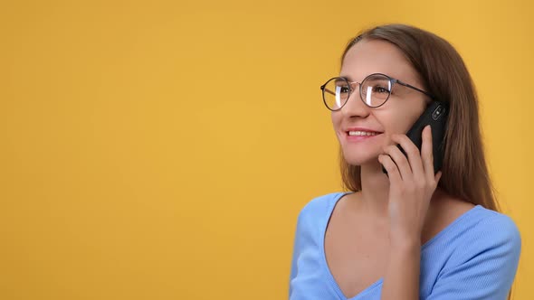 Closeup Blonde Woman in Eyeglasses Smiling Talking Smartphone Gesticulating with Positive Emotion