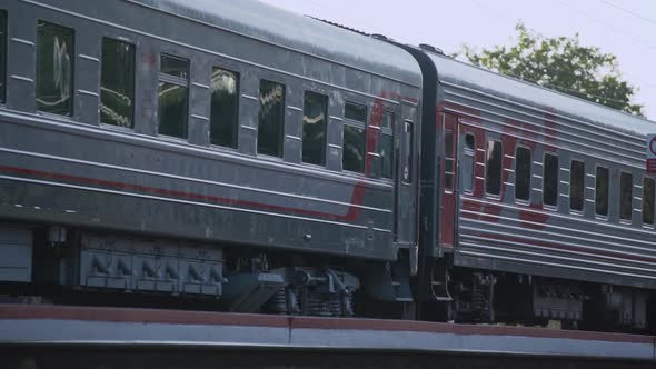 Grey Passenger Train Windows Reflect Blurred Cityscape