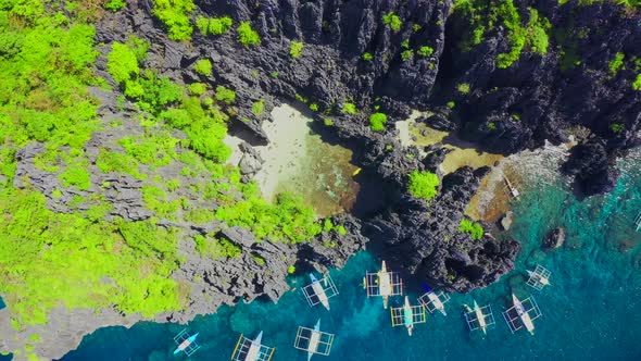 Aerial Drone View of Swimmers Inside a Tiny Hidden Tropical Lagoon Surrounded By Cliffs - Secret