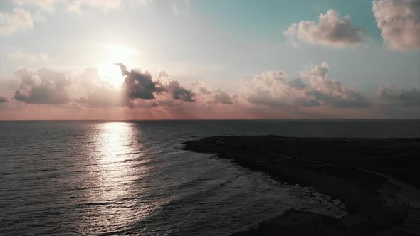 Aerial drone view of beautiful ocean sunset with empty tourist promenade