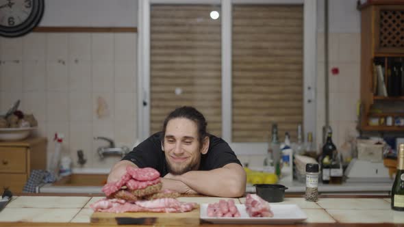 Meat Lover Delights in Front of Kitchen Counter Top Full of Meat Ready to Cook