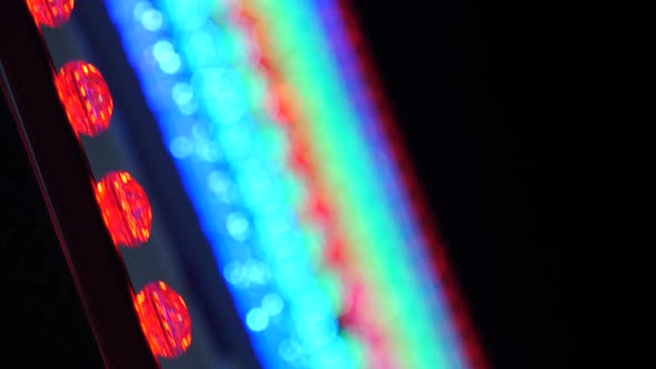 Neon Colored Lights on Carousel Ferris Wheel. Moon Night Bokeh in Amusement Park, Entertainment Zone