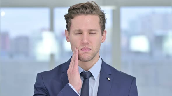 Portrait of Sick Young Businessman Having Toothache