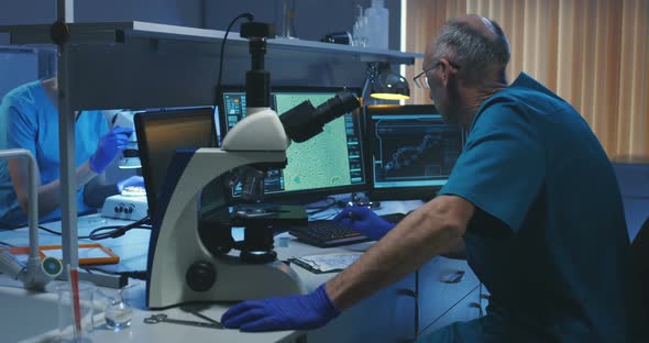 Biologist Analyzing Sample with Microscope alt