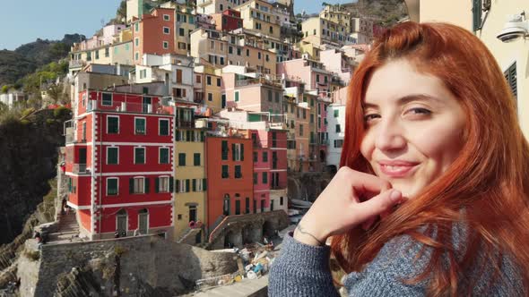 Tourist Girl Smiles and Has Fun in Riomaggiore City of the Cinque Terre