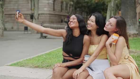 Multiethnic Girlfriends Taking Selfie in City