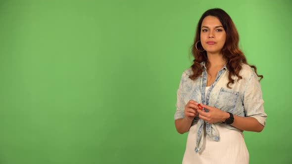 A Young Beautiful Caucasian Woman Eats Cherry Tomatoes  Green Screen Background