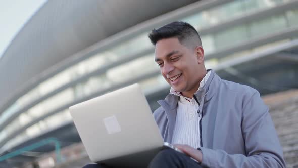 Smiling Handsome Young Man Using Laptop