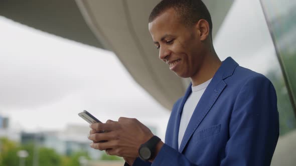 Cheerful Handsome Young Man Using Smartphone