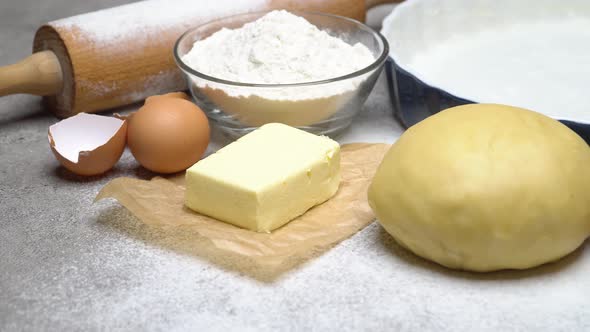 Unrolled and Unbaked Shortcrust Pastry Dough Recipe on Wooden Background