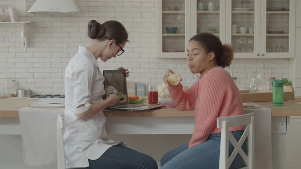 Nutritionist Showing Healthy Diet Plan To Patient