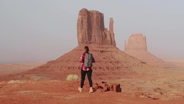 Cinematic Female Traveler Walking in Scenic Red Desert Park Landscape View