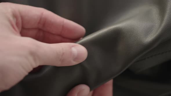 Top Down Shot of Man Hand Inspecting Soft Gray Leather