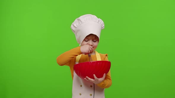 Child Girl Kid Dressed As Cook Baker Chef Mix Dough in Bowl Prepare Cake on Chroma Key Background