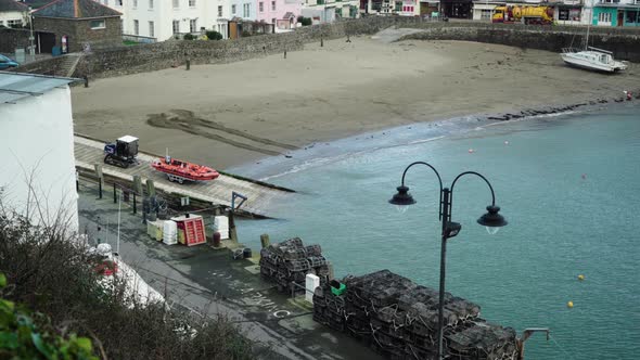 A Boat On A Trailer Being Launched By A Tractor Towards The Sea In Ilfracombe Harbour, Ilfracombe, U