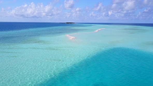 Drone aerial scenery of shore beach voyage by water with sand background