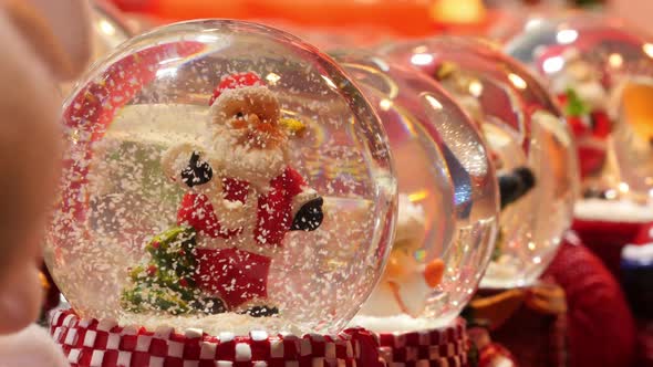 Christmas snow globes on display in a store