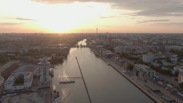 Berlin Cityscape Aerial Drone Shot over Spree River and Oberbaum Bridge at Sunset