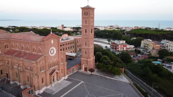 Orbiting around a church near the sea in Italy at dusk