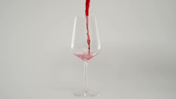 Pouring Red Wine in Glass at 1000 Fps Slow Motion Shot with White Background