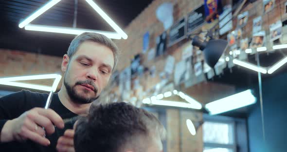 Male Stylist Working in a Hair Salon