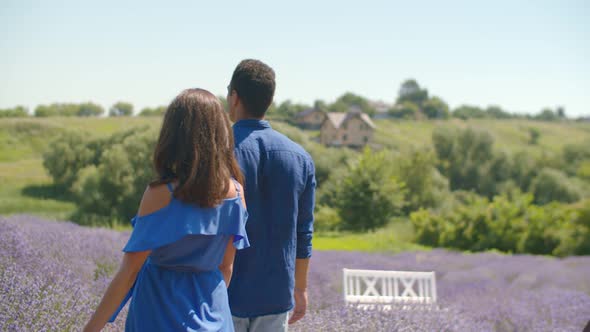 Affectionate Couple Walking in Lavender Field