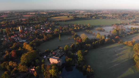 Aerial footage of Dedham featuring the village and church in the early morning with mist lying in th