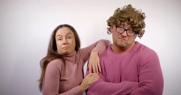 Grotesque Man with Wig and Artistic Woman Are Posing Jokingly for Camera, Medium Shot