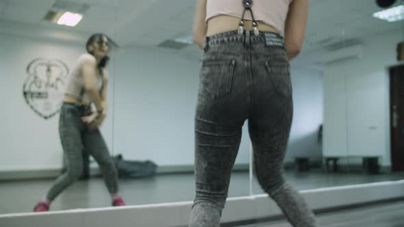 Caucasian female dancer choreographer performing a freestyle dancing with body waves in a dance stud