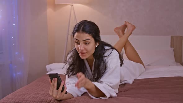 Happy Indian Young Woman Communicating By Conference Call Speak Looking at Smartphone at Home Video