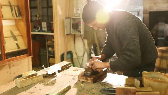 Bladesmith grinding a knife on grindstone