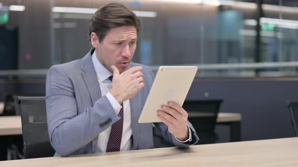 Middle Aged Businessman having Loss on Tablet 