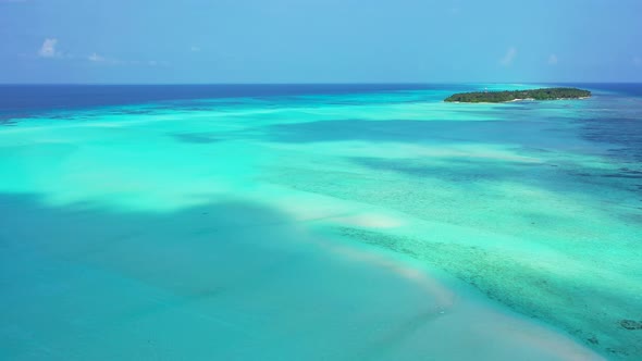 Wide angle above island view of a summer white paradise sand beach and aqua turquoise water backgrou