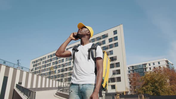 Portrait of a Handsome Young African American Food Delivery Courier Posing in