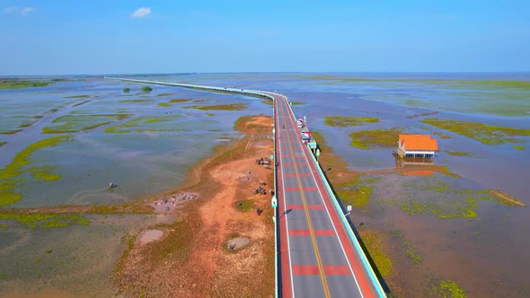 Drone video of the road leads through a large beautiful wetland.