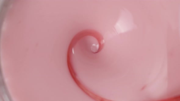Hypnotizing Rotation of a Strawberry Milkshake with a Thin Stream of Syrup, Viewed from Above
