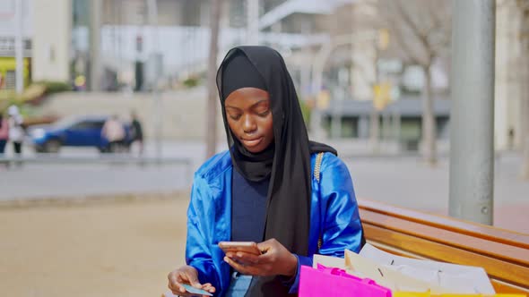 Black Female Doing Online Shopping on Bench