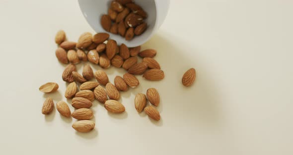 Video of almonds in a bowl on white background