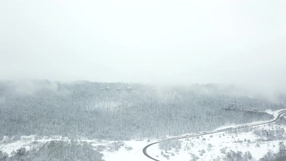 Drones Eye View  Winding Road From the High Mountain Pass in Winter