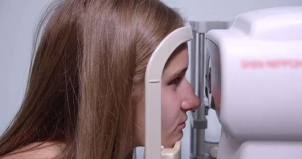 Young Woman Having Her Eyes Examined With Modern Medical Equipment 