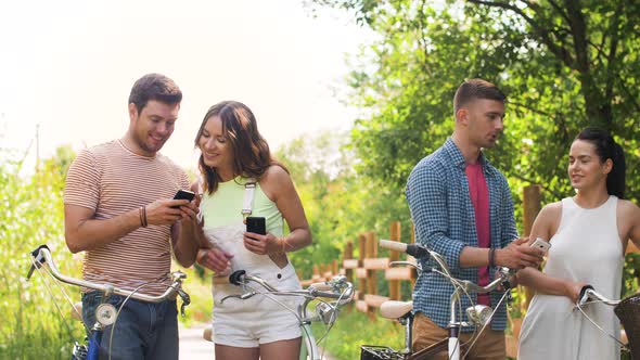 Friends with Bicycles and Smartphones at Park