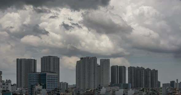 Time lapse of dramatic fast moving tropical storm clouds with urban high rise buildings.